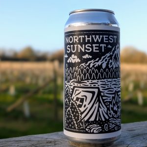 A close up of Northwest Sunset beer can with a vineyard backdrop